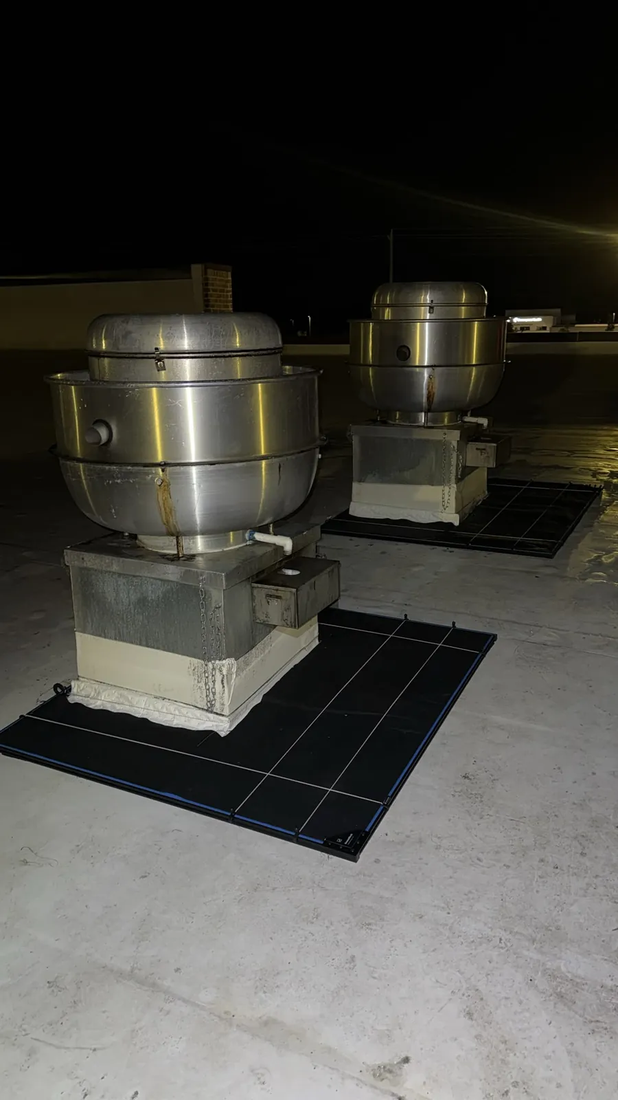 GreaseBlock containment installed around two restaurant rooftop exhaust fans